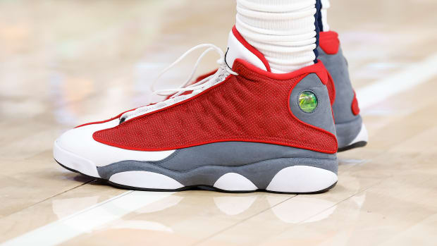 View of red, grey, and white Air Jordan shoes.